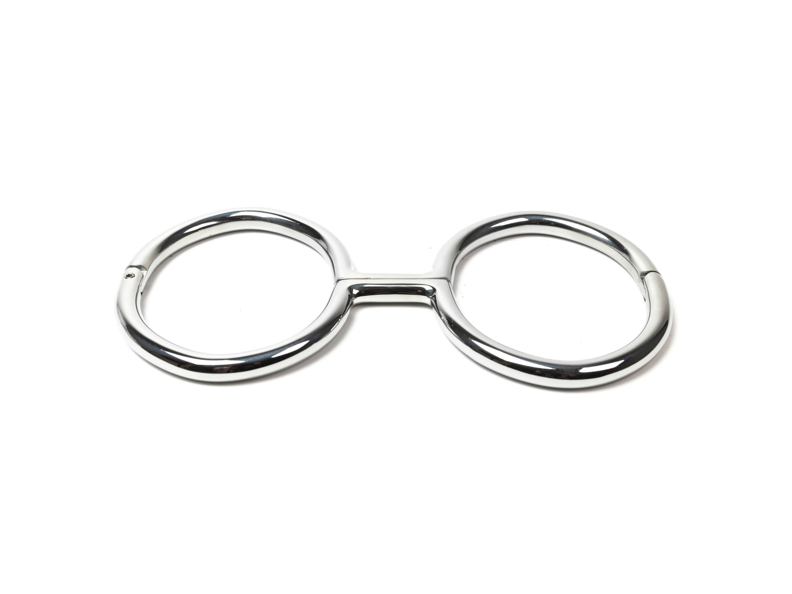 Rigid polished steel leg irons