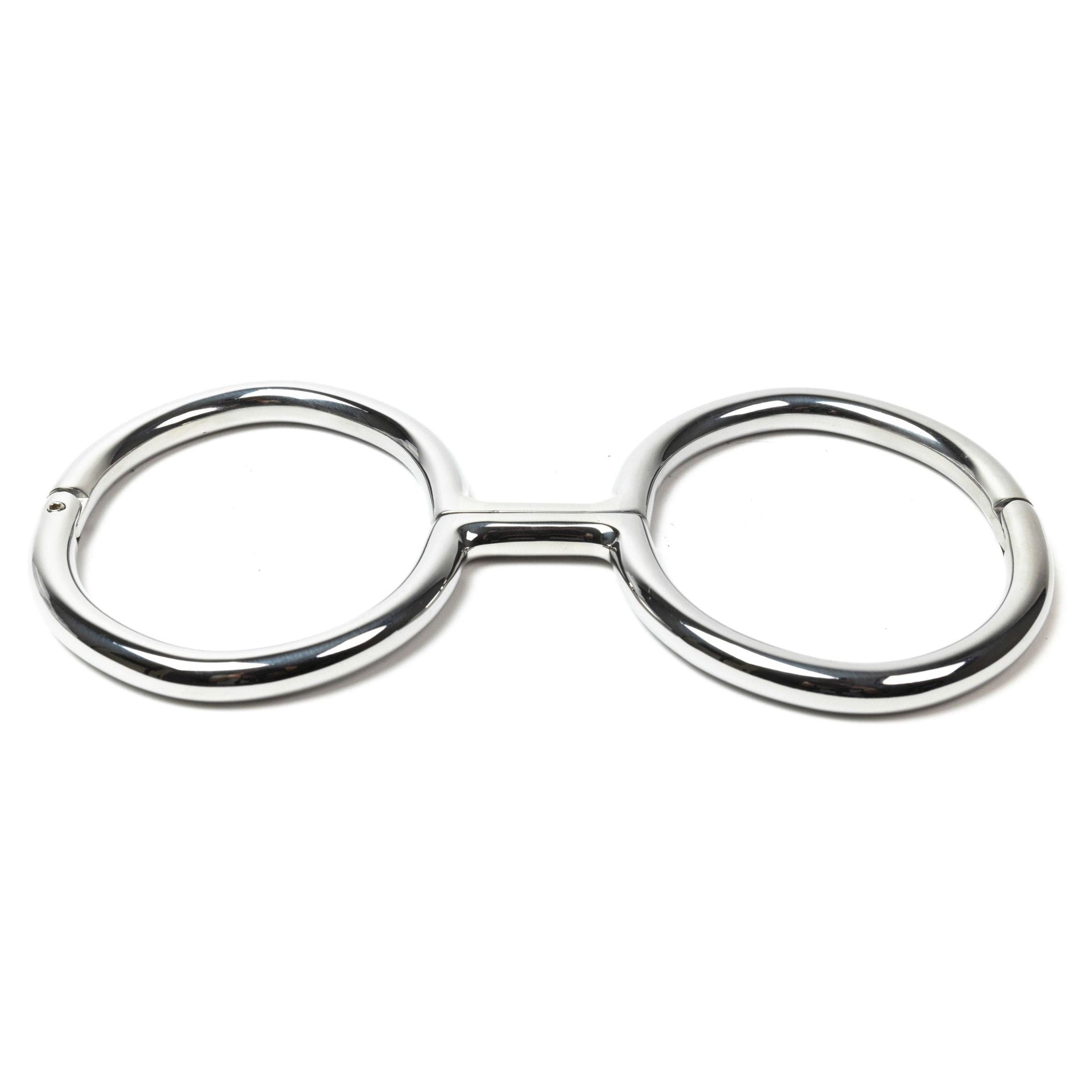 Rigid polished steel leg irons